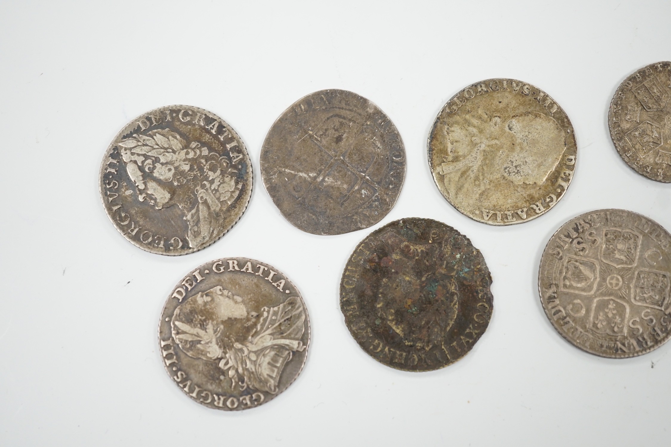 Four 18th century shillings, a sixpence an Elizabeth I coin and a token